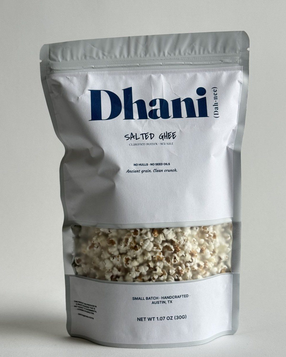 Dhani Salted Ghee — tiny popped sorghum in a stand-up bag with a window showing the popped grain